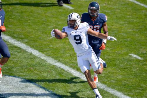 Chris Detrick  |  The Salt Lake Tribune
Brigham Young Cougars wide receiver Jordan Leslie (9) scores a touchdown past Virginia Cavaliers cornerback DreQuan Hoskey (22) during the game at LaVell Edwards Stadium Saturday September 20, 2014.  Virginia is winning the game 16-13 at halftime.