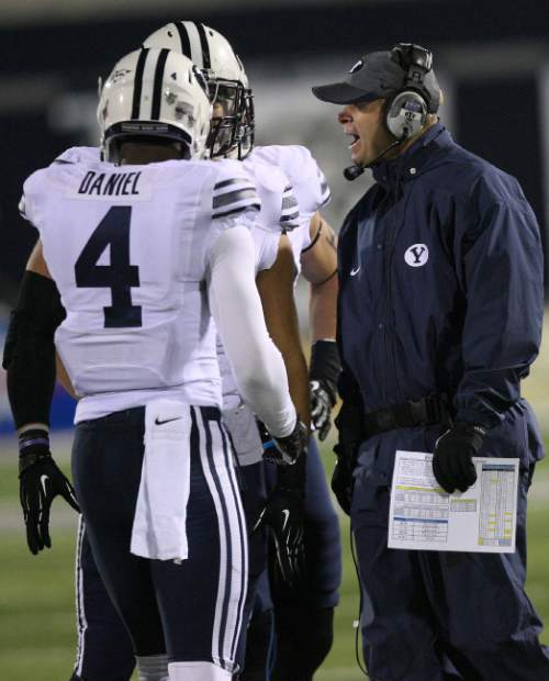 Leah Hogsten | The Salt Lake Tribune
BYU head coach Bronco Mendenhall talks with and Brigham Young Cougars defensive back Robertson Daniel (4). Brigham Young Cougars linebacker Kyle Van Noy (3) Brigham Young University Cougars defeatd Utah State University Aggies 31-14, Friday, October 4, 2013 in Logan.