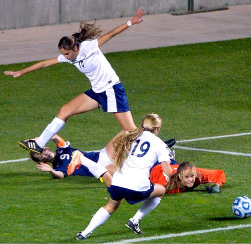 Chris Detrick  |  The Salt Lake Tribune
Timpanogos' Carly Nelson (23) makes a save past Skyline's Holly Daugirda (9) as Timpanogos' Olivia Burnett (16) jumps over her during the 4A girls' state soccer championship game at Rio Tinto Stadium Friday October 24, 2014.