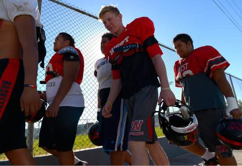 Leah Hogsten  |  The Salt Lake Tribune
l-r Team players walk past the Gean Plaga Stadium to the practice field.  West High School is the winningest football team in Utah history. West has revived its winning league title for the first time since 1995, and the team prepares for Friday's state tournament game during practice, October 29, 2014.