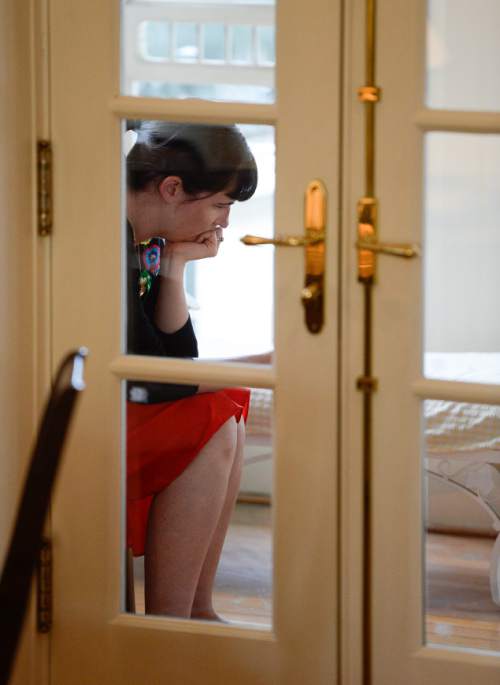 Francisco Kjolseth  |  The Salt Lake Tribune
Kate Kelly, founder of Ordain Women, checks messages of support and requests for interviews during a quiet moment at a bed and breakfast near the Church of Jesus Christ of Latter Day Saints after getting an official message through email that she has been excommunicated on Monday, June 23, 2014.