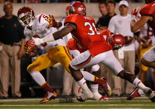 Scott Sommerdorf  |  The Salt Lake Tribune             
USC Trojans wide receiver Marqise Lee (9) tries to stiff-arm Utah Utes linebacker Victor Spikes (31) after a catch during first half play. Utah led USC 21-17 late in the first half, Thursday, October 4, 2012.