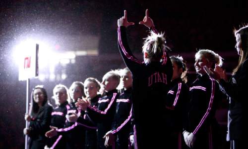 Staff Photo: Josh D. Weiss, Special to the Tribune
A University of Utah gymnast forms a U with her hands as the team is introduced during their meet against the University of Georgia Monday in Athens, Ga.  Utah was tied going into the final rotation but lost 196.725 to 197.150.