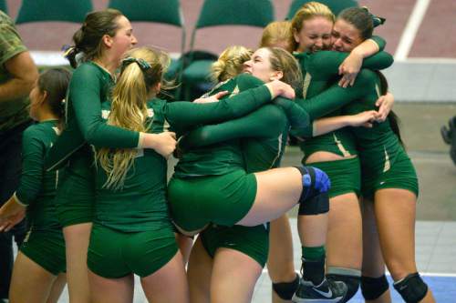 Chris Detrick  |  The Salt Lake Tribune
Members of the Snow Canyon volleyball team celebrate after winning the 3A state championship game at the UCCU Center at Utah Valley University Thursday October 30, 2014.
