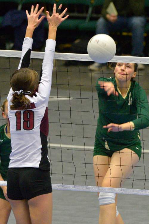Chris Detrick  |  The Salt Lake Tribune
Snow Canyon's Maggie Root (15) spikes the ball past Morgan's Anna Cox (19) during the 3A state championship game at the UCCU Center at Utah Valley University Thursday October 30, 2014.