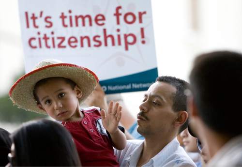 Kim Raff  |  The Salt Lake Tribune
(left) Josue and his father (right) Javier Vega sing along to a song during the Campaign for Citizenship prayer vigil at the Wallace Bennett Federal Building in Salt Lake City on June 27, 2013. This event is one of many held around the country to encourage a path to citizenship for undocumented Americans.