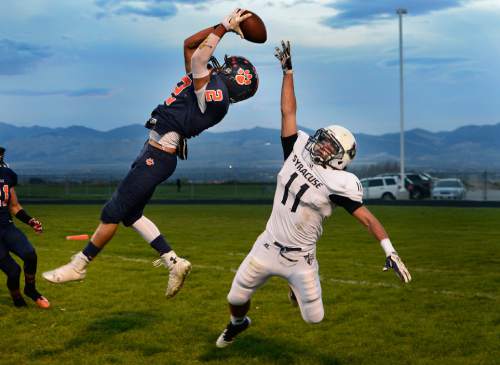 Scott Sommerdorf  |  The Salt Lake Tribune
Brighton DB Dylan Pearmain leaps to intercept a pass in the end zone intended for Syracuse WR Dax Harris during second half play. Brighton beat Syracuse 35-14 in a 5A first-round playoff game at Brighton, Friday, October 31, 2014.