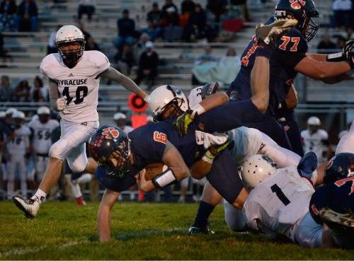 Scott Sommerdorf  |  The Salt Lake Tribune
Brighton QB Robbie Hutchins dives for a first down during second half play. Brighton beat Syracuse 35-14 in a 5A first-round playoff game at Brighton, Friday, October 31, 2014.