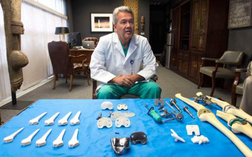 Steve Griffin  |  The Salt Lake Tribune


Orthopedic surgeon Lynn Rasmussen, of The Orthopedic Specialty Hospital in Murray, Utah, explains how an artificial knee joint functions in his office Wednesday, October 15, 2014. Rasmussen has developed a milling tool system, bottom right, that accurately lines up the knee for joint replacement.