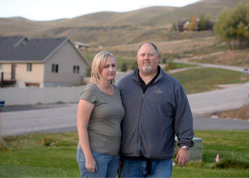 Rick Egan  |  The Salt Lake Tribune

 Martha and Clayton Ericson in front of their Morgan home, where the say a former neighbor filled the subdivision with smoke from a wood-fired boiler. The smoke triggered a lawsuit and illustrates the air-quality impacts of burning wood, but a judge last week concluded this smoke did pose a nuisance. 
Wednesday, October 15, 2014