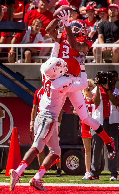 Trent Nelson  |  The Salt Lake Tribune
Utah Utes wide receiver Kenneth Scott (2) pulls in a touchdown reception over Fresno State Bulldogs defensive back Malcolm Washington (20) as Utah hosts Fresno State, college football at Rice-Eccles Stadium Saturday September 6, 2014.
