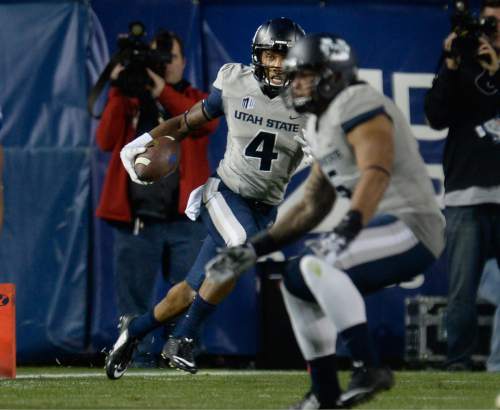 Scott Sommerdorf  |  The Salt Lake Tribune
Utah State Aggies wide receiver Hunter Sharp (4) runs during a first half play. Utah State led BYU 28-14 at the half in Provo, Friday, October 1, 2014.