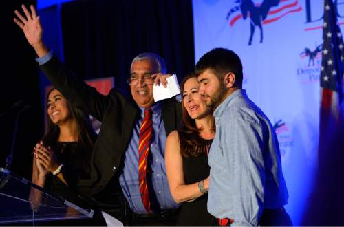 Leah Hogsten  |  The Salt Lake Tribune
District attorney­ Democratic incumbent Sim Gill is joined by his wife Jamie, daughter Anjali and son Nik during his acceptance speech at the Utah Democratic Party headquarters at the Radisson Hotel in Salt Lake City, November 4, 2014.