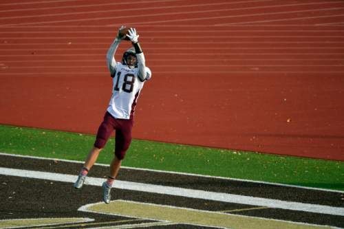 Chris Detrick  |  The Salt Lake Tribune
Jordan's John Villamore (18) makes a touchdown catch during the game at Davis High School Friday October 31, 2014.