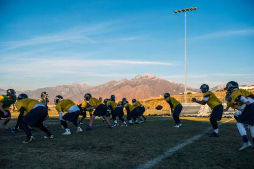 Chris Detrick  |  The Salt Lake Tribune
Members of the football team run drills during a practice at Summit Academy High School Wednesday November 5, 2014.