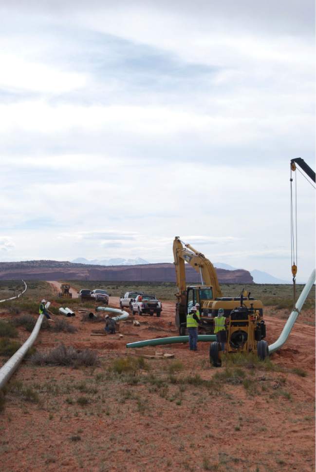 Brian Maffly  |  The Salt Lake Tribune

A crew assembles and installs a pipeline to move natural gas from Fidelity Exploration and Production Co.'s operations on Big Flat, a scenic recreational area outside Moab. This lateral line was completed last May and the company is poised to begin construction this month on a 26-mile network of gathering lines connecting with 19 well pads in the Cane Creek oil field.