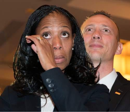 Steve Griffin  |  The Salt Lake Tribune


Mia Love wipes tears from her eyes as she stands with her husband, Jason, right, as she is introduced as the winner of her congressional race in Utah's 4th district  Salt Lake City, Wednesday, November 5, 2014.