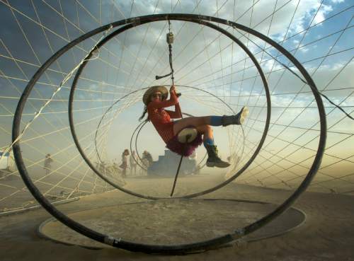 Rick Egan  |  The Salt Lake Tribune

Morgn Russon, Denver, Colorado, rides a zioline through the "Zymphonic Wormhole" at the Burning Man festival, in the Black Rock Desert, north or Reno Nevada, August 30, 2014.