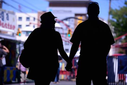 Scott Sommerdorf   |  The Salt Lake Tribune
A couple strolls through the Greek Festival hand in hand, Saturday, September 6, 2014.