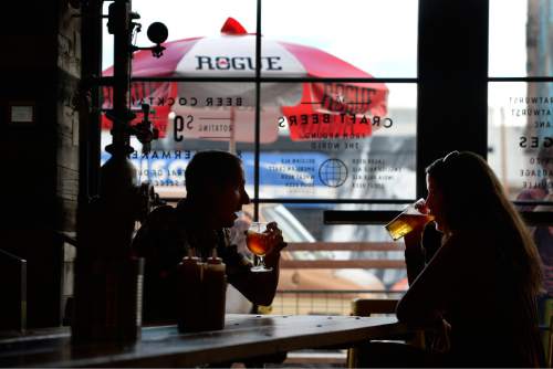 Scott Sommerdorf   |  The Salt Lake Tribune
Chad Redder and Meg Osswald talk over beers at Beer Bar in the Edison Quarter enclave, Thursday, August 21, 2014.