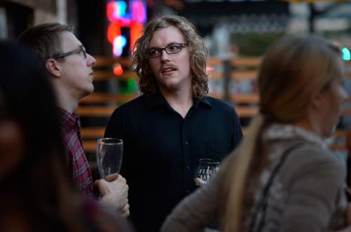 Scott Sommerdorf   |  The Salt Lake Tribune
Mike Elliott, center, chats with friends including Sam Demastrie, left at Beer Bar, Thursday, August 21, 2014.