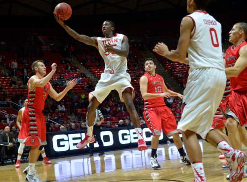 Chris Detrick  |  The Salt Lake Tribune
Utah Utes guard Delon Wright (55) shoots past Pacific Boxers Coby Proctor (2) and Pacific Boxers Bobby Ahern (10) during the game at the Huntsman Center Thursday November 6, 2014.