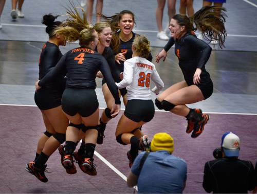 Scott Sommerdorf  |  The Salt Lake Tribune
Timpview players celebrate their 4A championship after they defeated Sky View 3-0 in their volleyball championship match at UCCU, Saturday, November 8, 2014 in Provo.