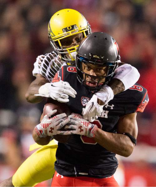Rick Egan  |  The Salt Lake Tribune

Oregon Ducks defensive back Troy Hill (13) tries to stop Utah wide receiver Kaelin Clay (8) after he hauls in a long pass for the Utes, in Pac-12 football action, Utah vs. Oregon game, at Rice-Eccles Stadium, Saturday, November 8, 2014