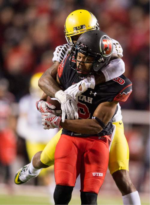 Rick Egan  |  The Salt Lake Tribune

Oregon Ducks defensive back Troy Hill (13) tries to stop Utah wide receiver Kaelin Clay (8) after he hauls in a long pass for the Utes, in Pac-12 football action, Utah vs. Oregon game, at Rice-Eccles Stadium, Saturday, November 8, 2014