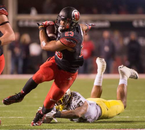 Rick Egan  |  The Salt Lake Tribune

 Ute running back Devontae Booker (23) slips out of the hands of Oregon Ducks linebacker Tyson Coleman (33) as he runs the ball into the end zone for a touchdown, in Pac-12 football action, Utah vs. Oregon game, at Rice-Eccles Stadium, Saturday, November 8, 2014