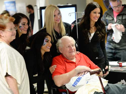 Francisco Kjolseth  |  The Salt Lake Tribune
Veteran Arnold Pye poses for a picture with some of the Utah Jazz Dancers as the VA hospital in Salt Lake hosts an event to help veterans learn about services available to them.