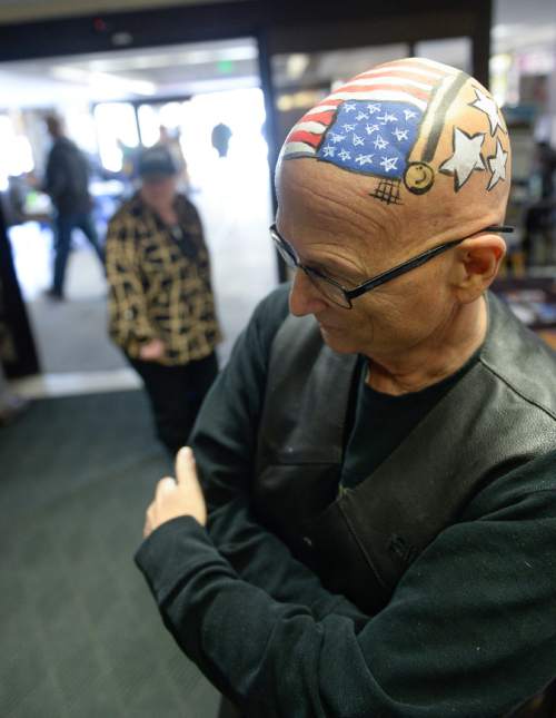 Francisco Kjolseth  |  The Salt Lake Tribune
David "Harley" Davis, a Vietnam veteran from Spanish Fork, takes advantage of a smooth head to add a little color while undergoing treatments at the VA Hospital in Salt Lake for his leukemia. The Veterans Hospital hosted Jazz Dancers and "radio celebrities" during the event to help veterans learn about services available to them.