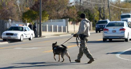 Francisco Kjolseth  |  The Salt Lake Tribune
A canine unit combs the neighborhood in search of a suspect as police put four area schools on lockdown in Magna after reports that a student brought a gun to Brockbank Jr. High on Tuesday, Nov. 11, 2014. The weapon turned out to be a toy.