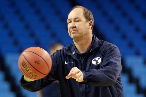 Brigham Young University head coach Jeff Judkins passes the ball during practice for the NCAA women's college basketball tournament on Friday, March 21, 2014, in Los Angeles. BYU is scheduled to play North Carolina State in a first-round game on Saturday. (AP Photo/Jae C. Hong)