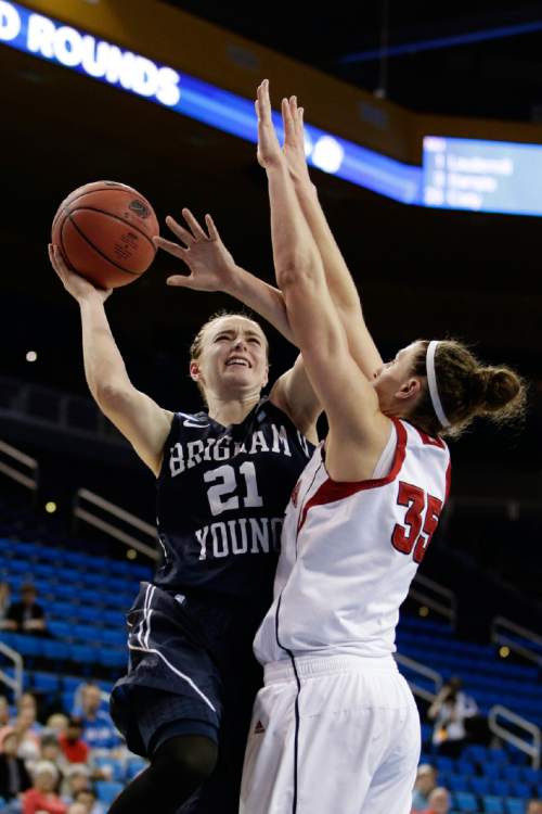 BYU's Lexi Eaton (21) goes up for a basket against Nebraska's Jordan Hooper (35) during the first half of a second-round game in the NCAA women's college basketball tournament on Monday, March 24, 2014, in Los Angeles. (AP Photo/Jae C. Hong)