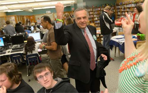 Al Hartmann  |  The Salt Lake Tribune
Utah Commissioner of Higher Education Dave Buhler rises his arm to show the neon bracelet seniors wear after completing online college application Wednesday November 12 at Kearns High School.  Thirty Kearns High School seniors applied for state colleges as party of Utah College Application Week.