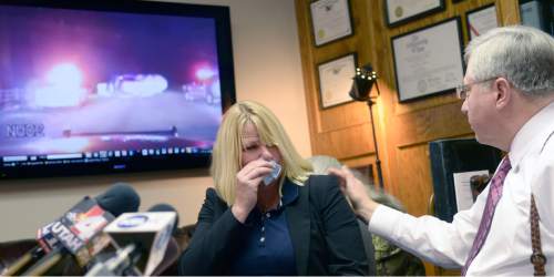 Al Hartmann  |  The Salt Lake Tribune
Kristine Biggs Johnson breaks down as her attorney Bob Sykes, plays a Youtube video from a law enforcement dashcam when she was shot in the eye November 2012.  Her attorney Bob Sykes is filing a federal civil rights lawsuit Thursday November 13 against a Morgan County Sheriff's deputy for improper use of deadly force against her. The shooting was deemed unjustified by Davis County Attorney Troy Rawlings, but no charges were filed against the deputy.