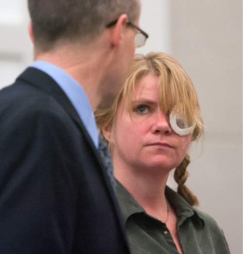 Steve Griffin | The Salt Lake Tribune

Kristine Biggs, who was shot in the eye by a Morgan County police officer after leading them on a chase, talks with her attorney, Michael Edwards, during her sentencing hearing for charges related to the incident at the Davis County Justice Complex  in Farmington, Utah Monday February 25, 2013.