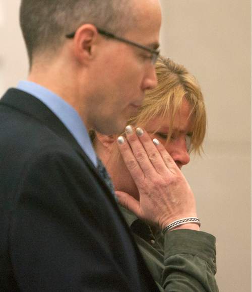 Steve Griffin | The Salt Lake Tribune

Kristine Biggs, who was shot in the eye by a Morgan County police officer after leading them on a chase, wipes tears away as she stands with her attorney, Michael Edwards, during her sentencing hearing for charges related to the incident at the Davis County Justice Complex  in Farmington, Utah Monday February 25, 2013.