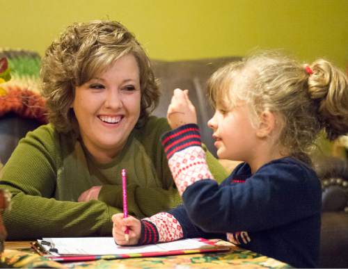 Rick Egan  |  The Salt Lake Tribune

 Alicia Hobson helps her a 6-year-old daughter Azlyn with her homework, in her home in Lehi, Tuesday, November 11, 2014
