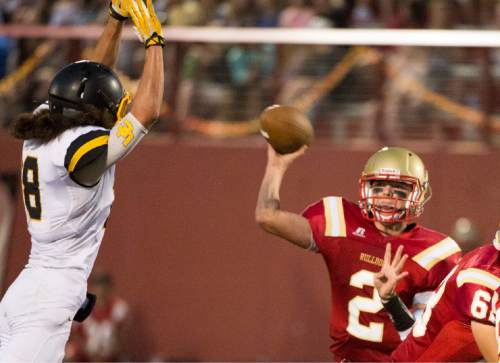 Rick Egan  |  The Salt Lake Tribune

Ayden Auer throws a pass for Judge Memorial, as Vil Lutui (18) defends for Union, in prep football action at Judge Memorial, Friday, September 19, 2014