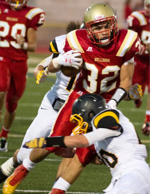 Rick Egan  |  The Salt Lake Tribune

Michael Kearns (32) runs for Judge Memorial,  in prep football action Judge Memorial vs. Union High School, at Judge Memorial, Friday, September 19, 2014