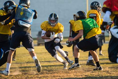 Chris Detrick  |  The Salt Lake Tribune
Steven Harp runs the ball during a practice at Summit Academy High School Wednesday November 5, 2014.