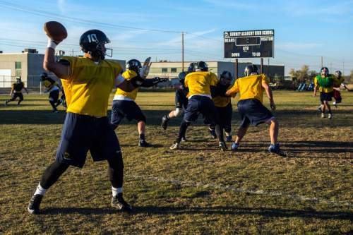 Chris Detrick  |  The Salt Lake Tribune
Quarterback Hagan Hines passes the ball during a practice at Summit Academy High School Wednesday November 5, 2014.