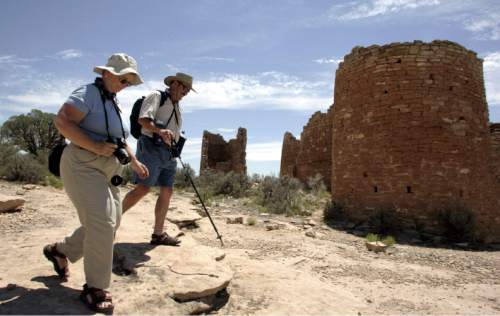 Wendy and Scott Henderson, of Livermore, Calif., walk past Hovenweep Castle at Hovenweep National Monument in southern Utah. 7/20/06 Jim Urquhart/Salt Lake Tribune