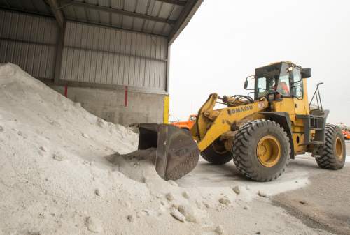 Rick Egan  |  The Salt Lake Tribune

Salt is gathered up to be dumped into is loaded into a snow plow at the maintenance yard, during a press conference about UDOT's preparations to handle the snow this winter, Thursday, November 13, 2014