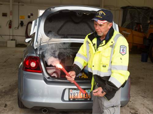 Rick Egan  |  The Salt Lake Tribune

Jeff Reynolds, state wide manager for the Incident Management Team, lights a flare as he talks to the media about items recommended for everyone to have in thier trunk for winter driving, Thursday, November 13, 2014