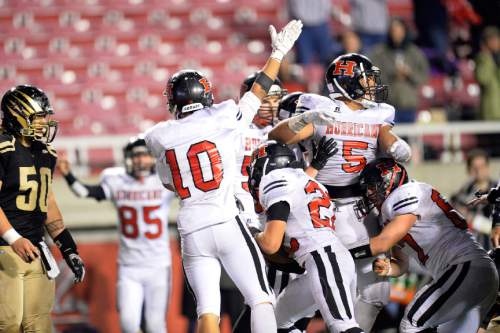 Chris Detrick  |  The Salt Lake Tribune
Members of the Hurricane football team celebrate after recovering a fumble in the final seconds the 3AA state football semifinal game at Rice-Eccles Stadium Friday November 14, 2014. Hurricane defeated Desert Hills 17-14.