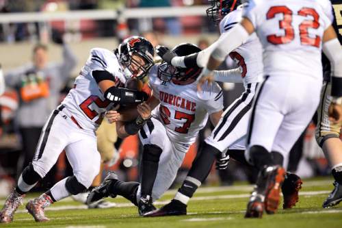 Chris Detrick  |  The Salt Lake Tribune
Hurricane's Tyson Yardley (22) recovers a fumble in the final seconds of the 3AA state football semifinal game at Rice-Eccles Stadium Friday November 14, 2014. Hurricane defeated Desert Hills 17-14.