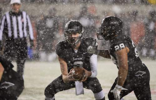 Francisco Kjolseth  |  The Salt Lake Tribune
Heavy snow falls as Pine View quarter back Kody Wilstead (3)  passes the ball off to Pano Tiatia (29) while taking on Dixie in the class 3AA state football semifinal game at Rice Eccles Stadium on Thursday, Nov. 13, 2014.